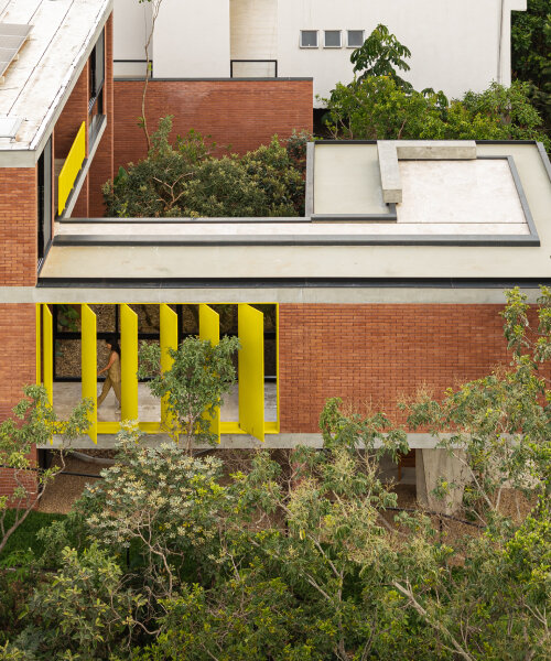 bold yellow louvers bring brazilian forest into house of 7 trees by hersen mendes arquitectura