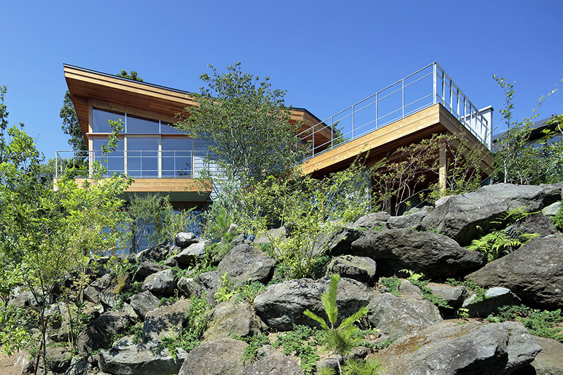 hybrid live-work spaces compose stone residence by FEDL in japanese hillside