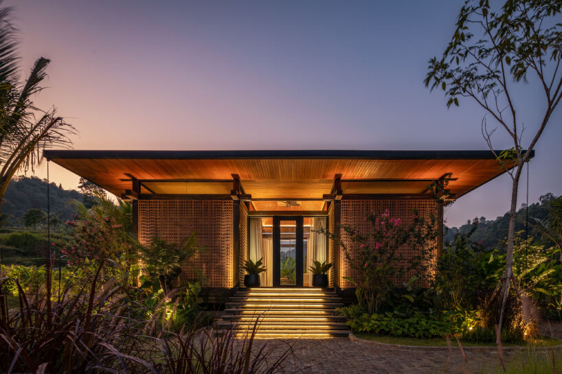 undulating wood and bamboo top k-thengono's wedding compound in indonesia rice fields