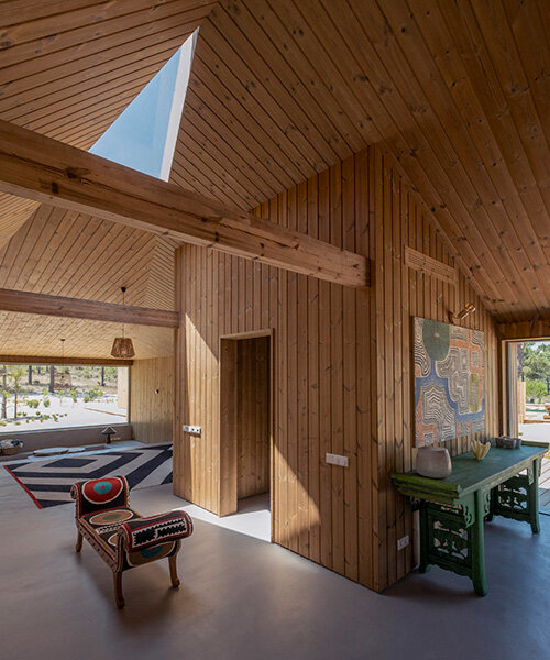 donavan house: PIMAA clusters timber dwellings along sandy coastal site in portugal