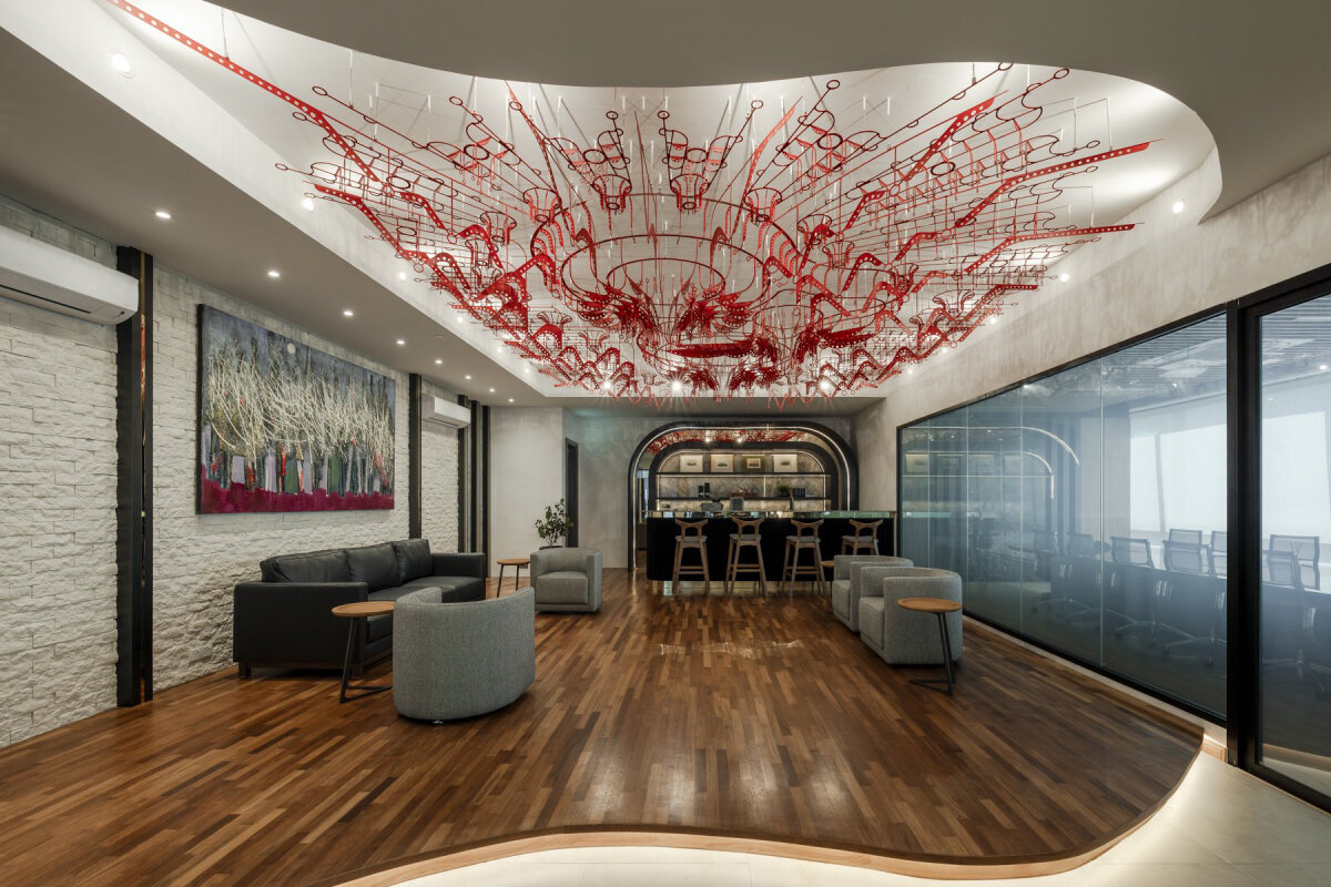poh sin studio's suspended red installation evokes intricate mechanical conduits in malaysia