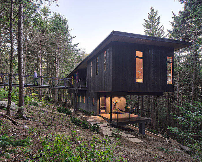 two cantilevered boxes of dark cedar shape altura architects' spruce ridge cabin