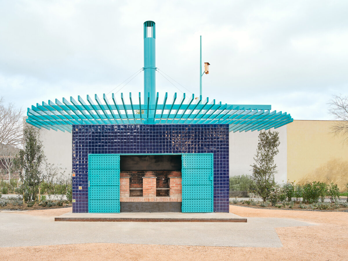 ceramic blue tiles evoking mediterranean hues clad h3o architects' public barbecue in spain
