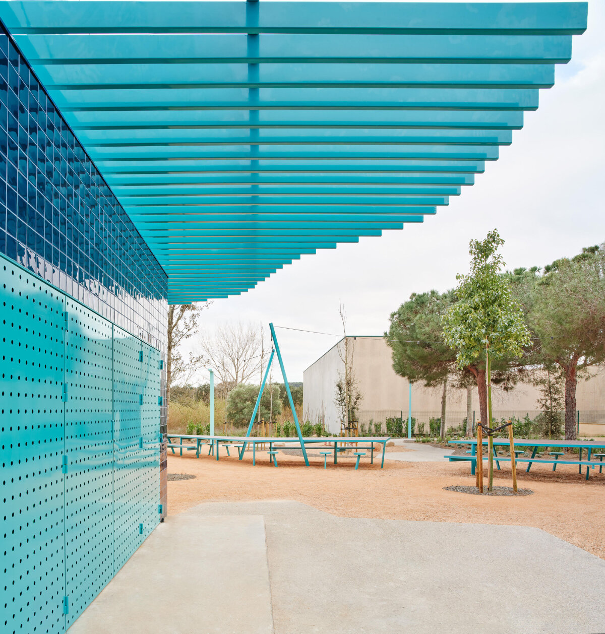ceramic blue tiles evoking mediterranean clad h3o architects' communal barbecue in spain