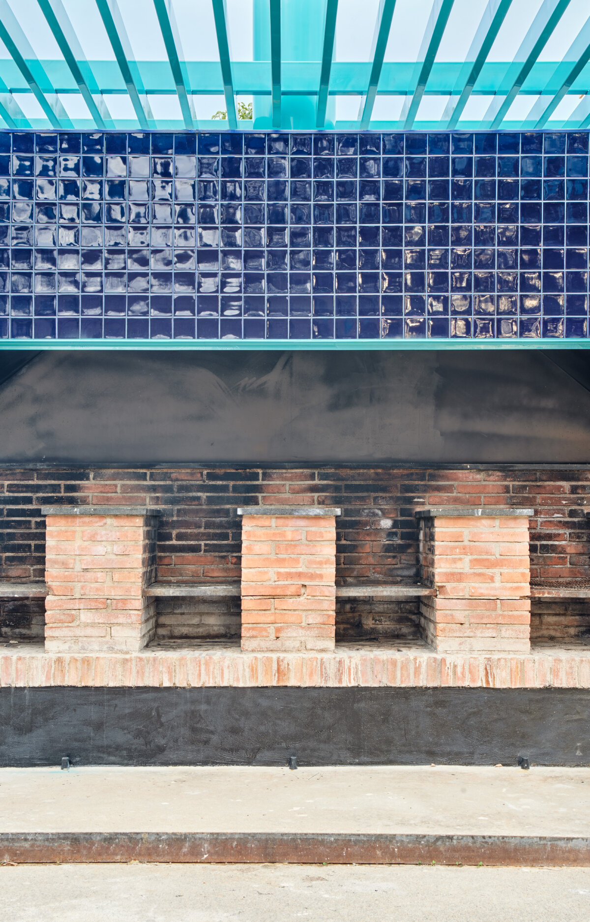 ceramic blue tiles evoking mediterranean clad h3o architects' communal barbecue in spain