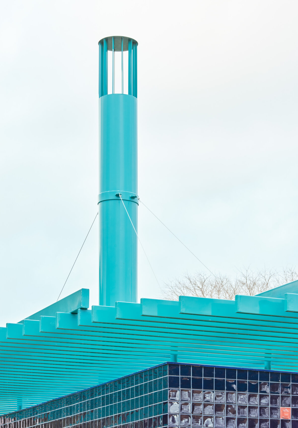 ceramic blue tiles evoking mediterranean clad h3o architects' communal barbecue in spain