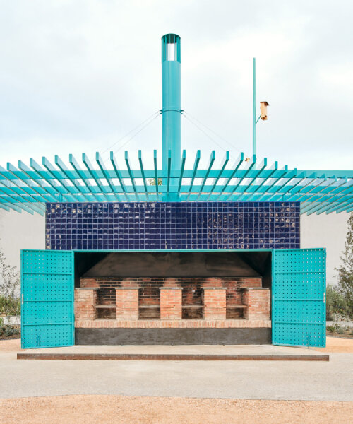 ceramic blue tiles evoking mediterranean clad h3o architects' communal barbecue in spain