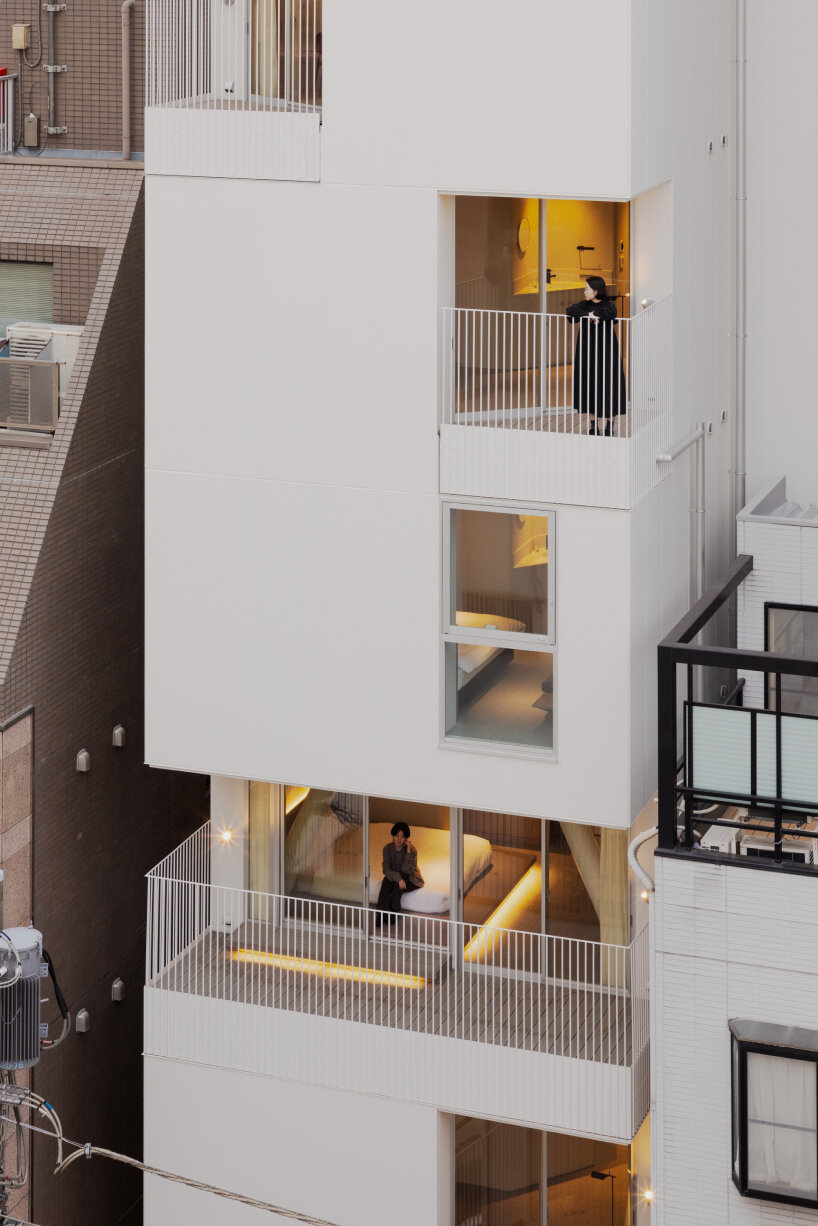 kooo architects carves luminous terraces into hotel facade on narrow, downtown tokyo lot