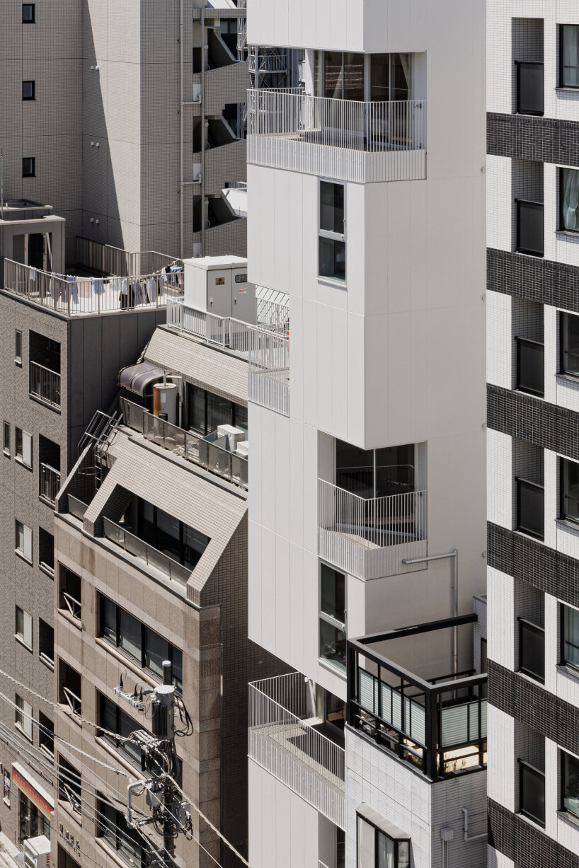 kooo architects carves luminous terraces into hotel facade on narrow, downtown tokyo lot