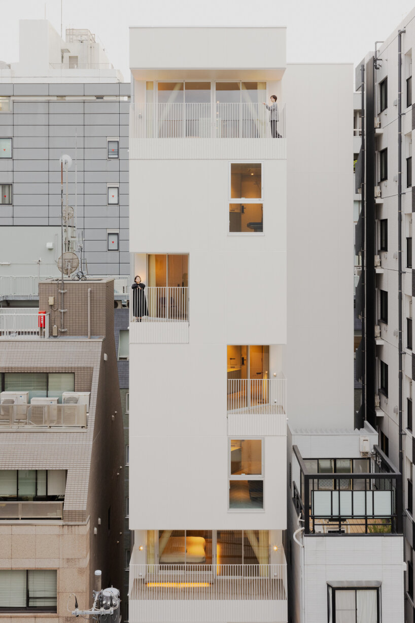 kooo architects carves luminous terraces into hotel facade on narrow, downtown tokyo lot