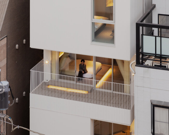 kooo architects carves luminous terraces into hotel facade on narrow, downtown tokyo lot