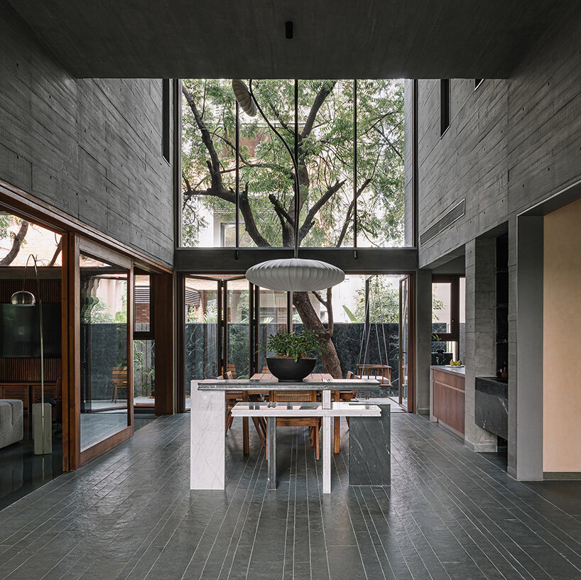 square openings punctuate wood-textured concrete facade of studio saransh's house in india