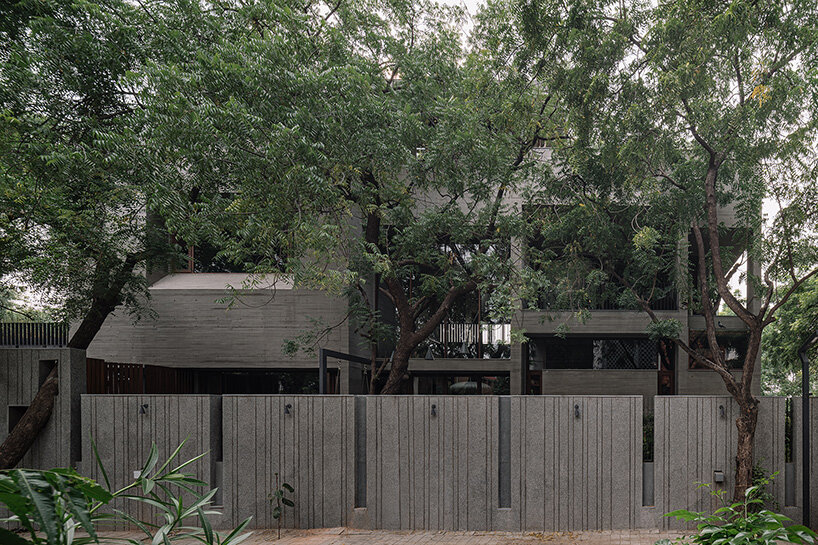 square openings punctuate wood-textured concrete facade of studio saransh's house in india