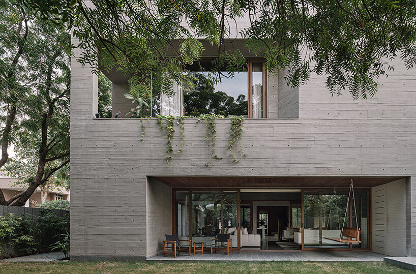 square openings punctuate wood-textured concrete facade of studio saransh's house in india