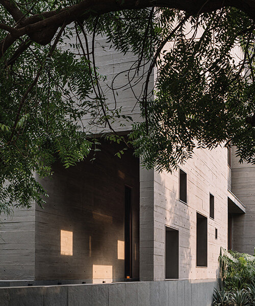 square openings punctuate wood-textured concrete facade of studio saransh's house in india