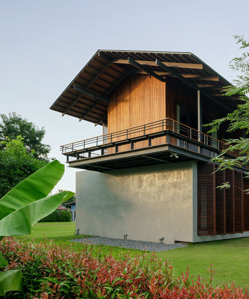 facade of repurposed wood fronts multi-generational house in uthai thani, thailand