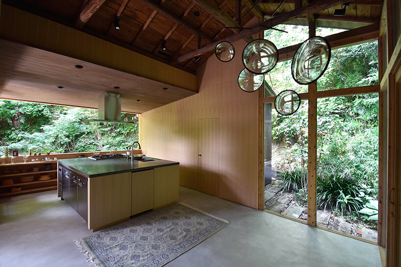 wooden atelier rises from preserved framework of 90-year-old japanese home