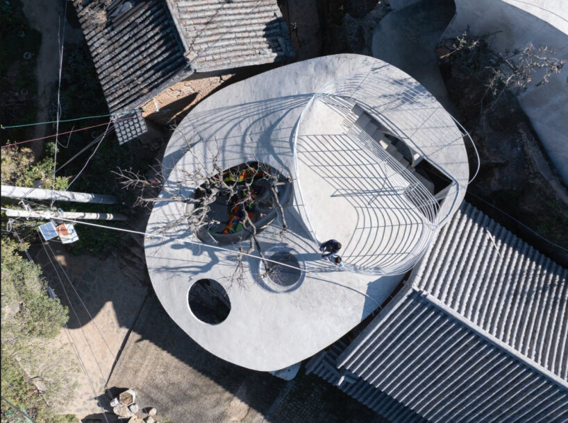 xong xiangwei studio's concrete mushroom library creates reading space for children in china