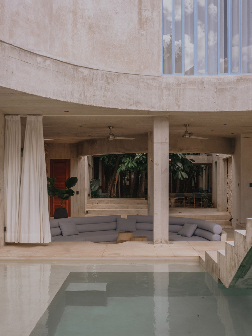 mexican house by ludwig godefroy unfolds as a porous concrete shell around lush courtyards