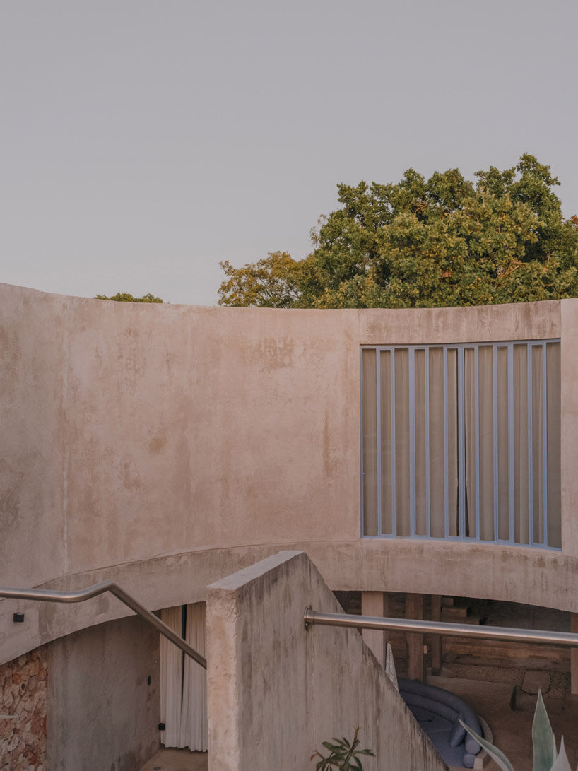 mexican house by ludwig godefroy unfolds as a porous concrete shell around lush courtyards