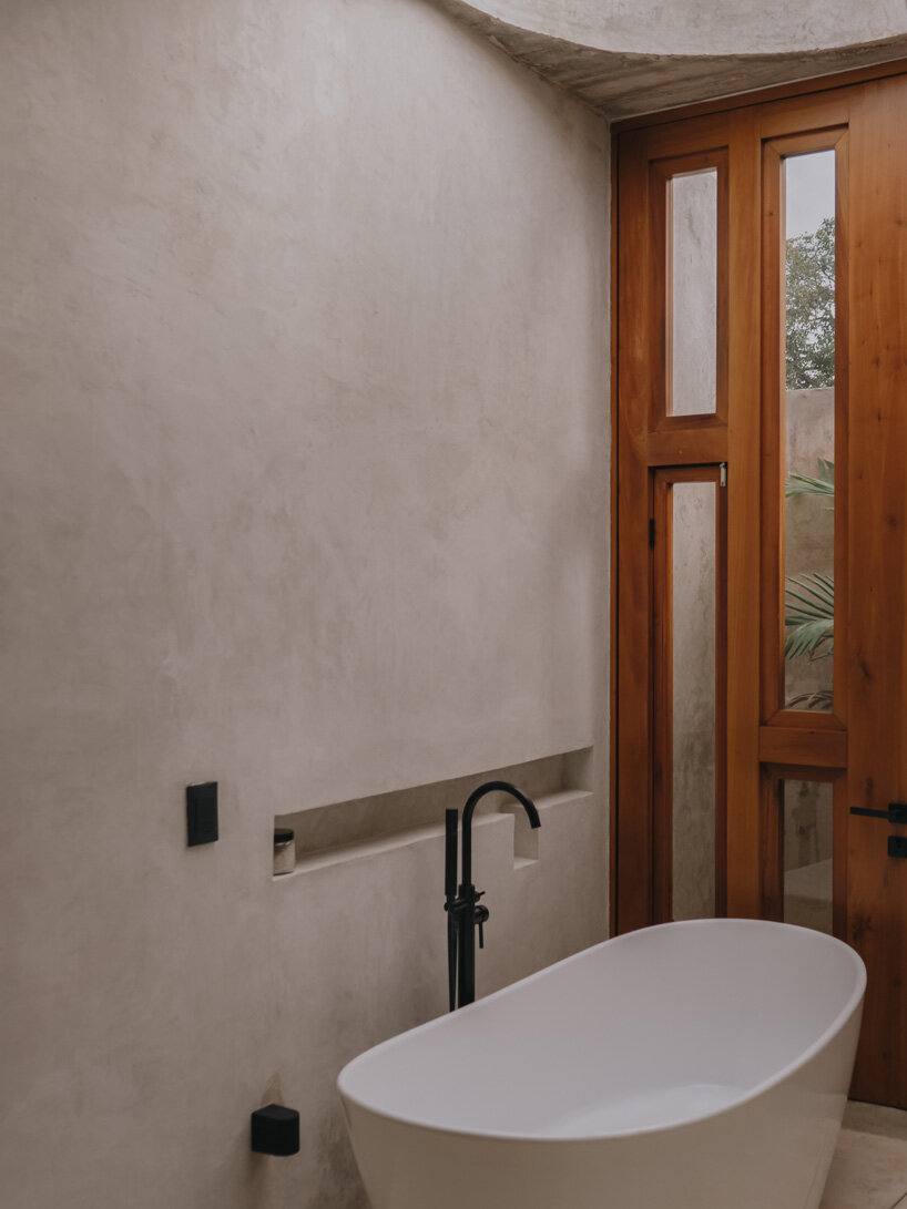 mexican house by ludwig godefroy unfolds as a porous concrete shell around lush courtyards
