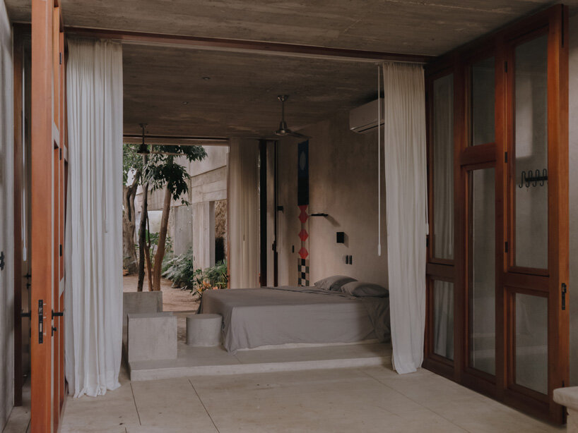 mexican house by ludwig godefroy unfolds as a porous concrete shell around lush courtyards