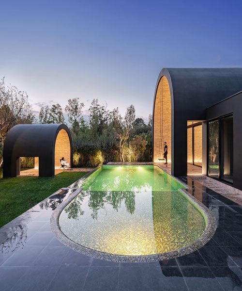 semi-enclosed vaulted residence by super void space splits across narrow water body in iran