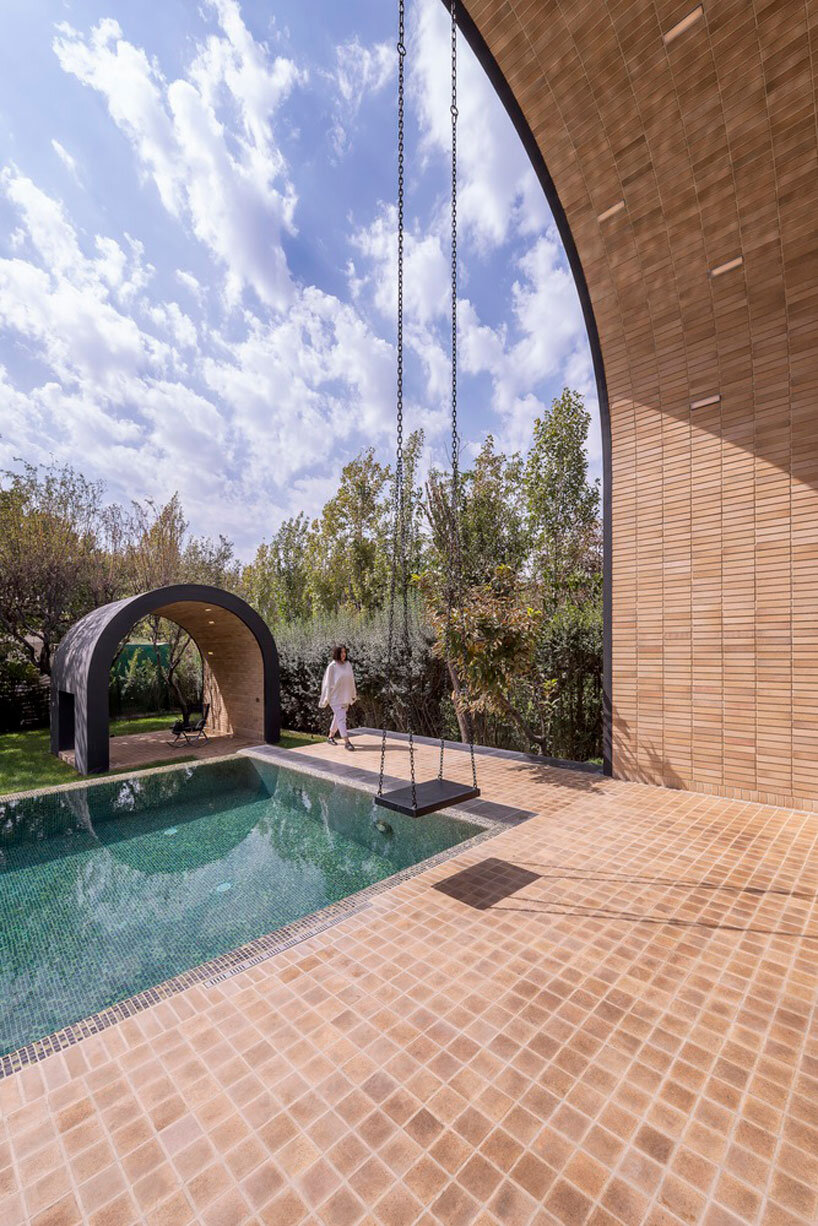 semi-enclosed vaulted residence by super void space splits across narrow water body in iran