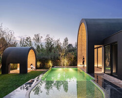semi-enclosed vaulted residence by super void space splits across narrow water body in iran