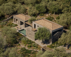 rough stone textures interplay with smooth gray cement for enigma project in paxos island
