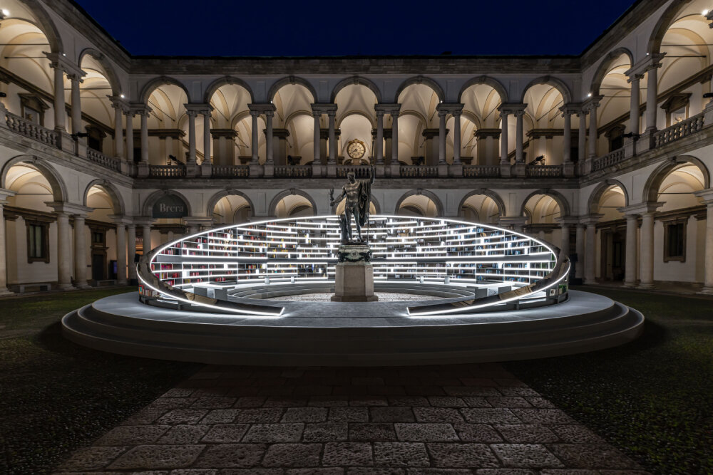 es devlin's rotating library installation illuminates historic courtyard at milan design week