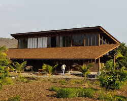 metis practice combines wooden shingles and copper for pali farmhouse's roofing in india