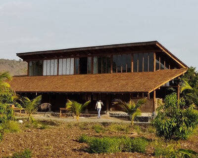 metis practice combines wooden shingles and copper for pali farmhouse's roofing in india
