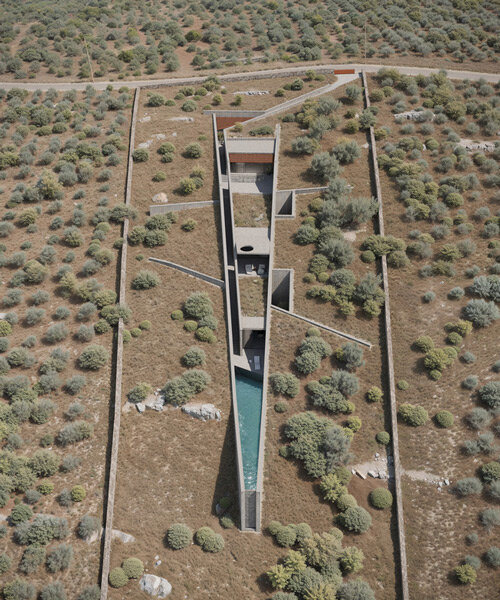 mykonos architects embeds wedge-shaped n'arrow house into terrain of crete