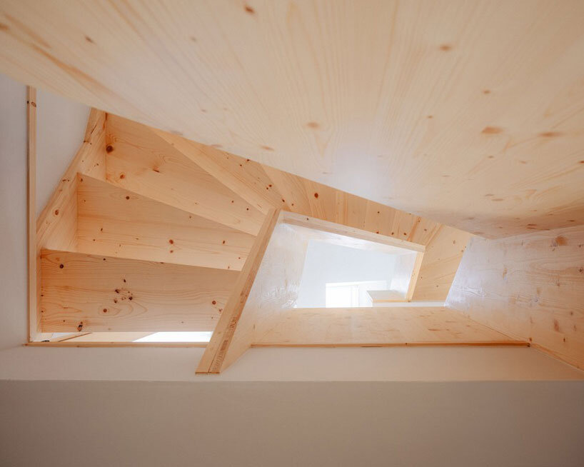 dark wooden slats coat house in saint-malo by maab architectes, sitting on stone plinth