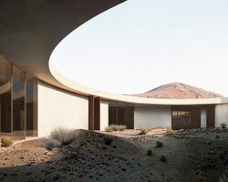 pragma carves rock art visitor's center into rugged terrain of archaeological site in UAE