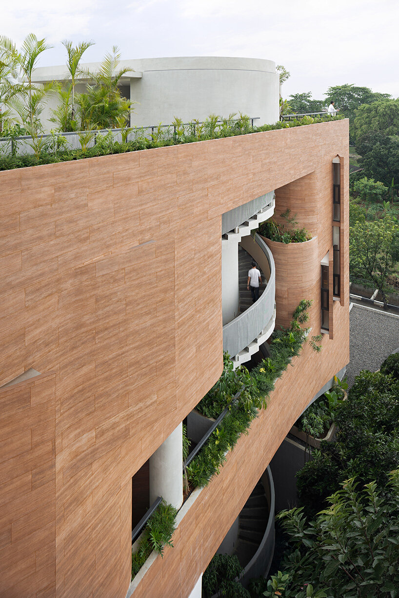 RAD+ar punctures arched facade to protect office building from jakarta's humid climate