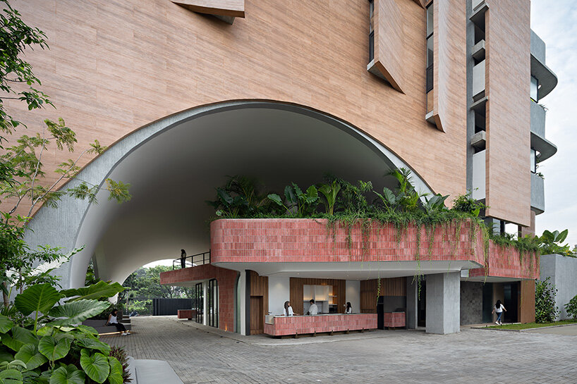 RAD+ar punctures arched facade to protect office building from jakarta's humid climate