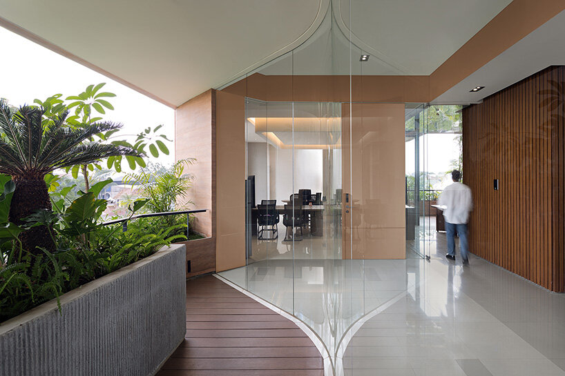 RAD+ar punctures arched facade to protect office building from jakarta's humid climate