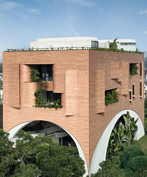 RAD+ar punctures arched facade to protect office building from jakarta's humid climate