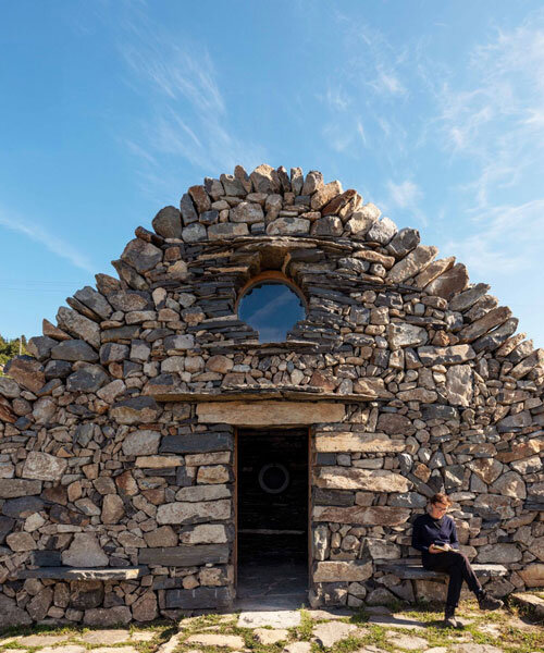 suchaillou stone shelter embeds within rocky outcrop along santiago de compostela route