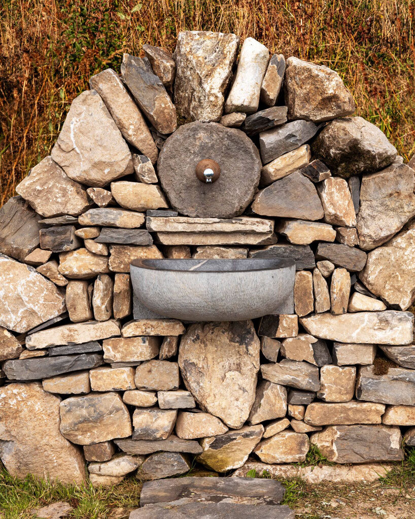 suchaillou stone shelter embeds within rocky outcrop along santiago de compostela route
