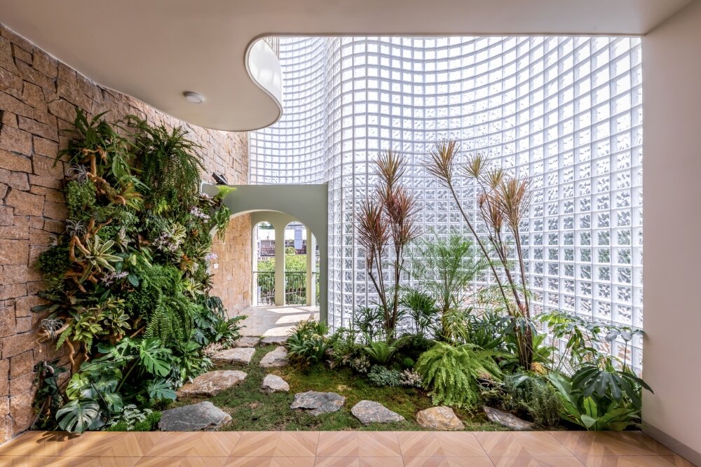 undulating facade of 3,000 glass bricks wraps DA VÀNG studio's crystal pavilion house in vietnam