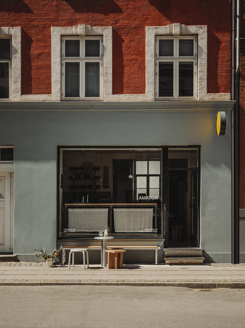 wiercinski-studio builds cozy 'amator' restaurant around modular oak table in copenhagen