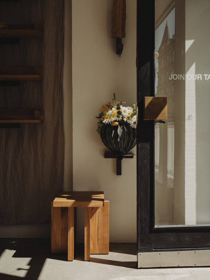 wiercinski-studio builds cozy 'amator' restaurant around modular oak table in copenhagen