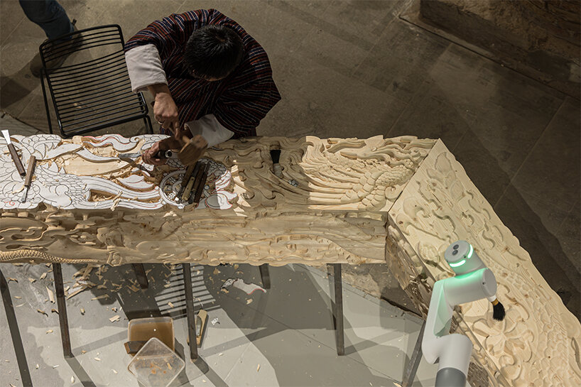 BIG's 'ancient future' fuses hand-carving and robotics at venice biennale 2025