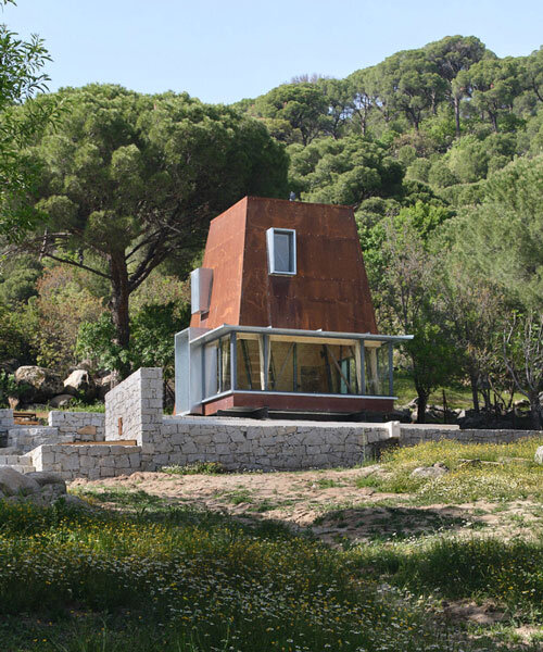 corten steel angular cabin emerges amongst pergamon forests in turkey