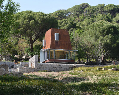 corten steel angular cabin emerges amongst pergamon forests in turkey