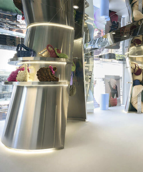 mirroring steel coats carlyn showroom's fluid curved interiors in seoul