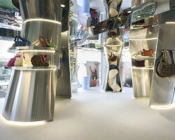 reflective steel coats carlyn showroom's fluid curved interiors in seoul